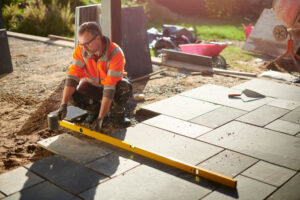 Man installing pavement using tools at Orange County, CA